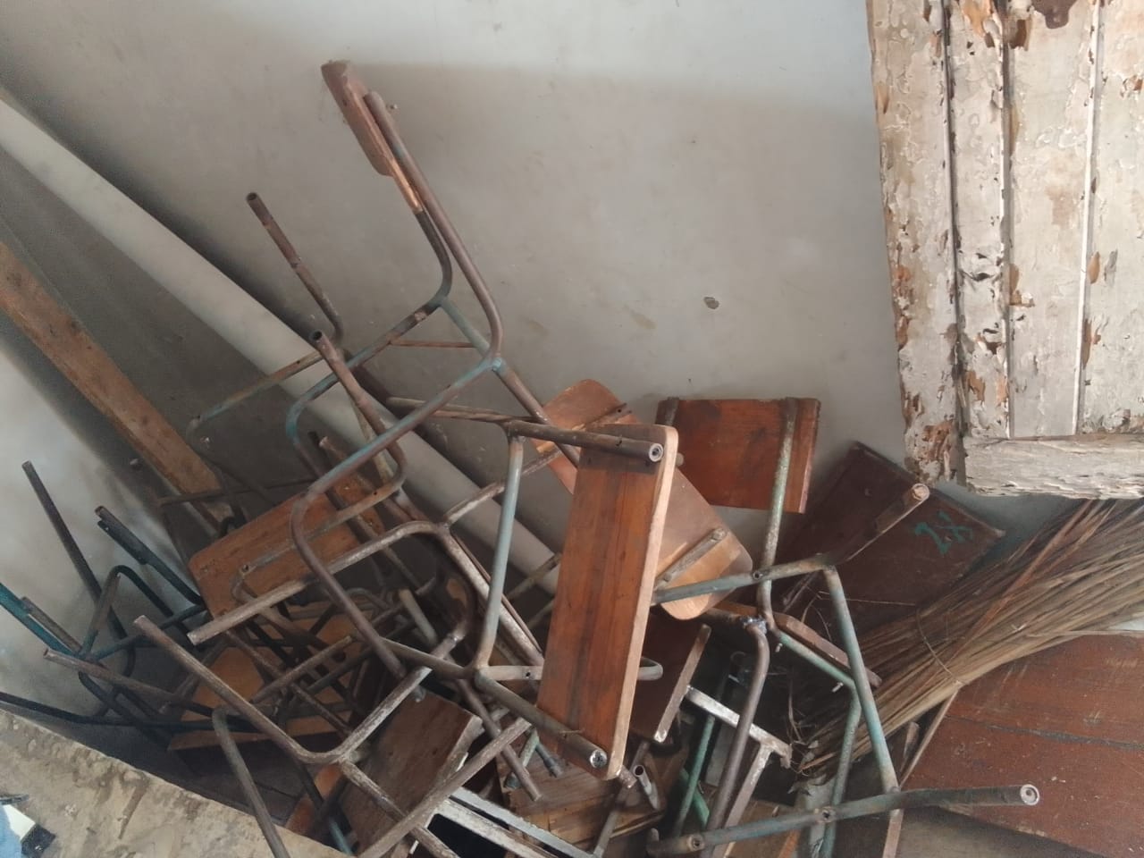 Old wooden desks showing wear and tear